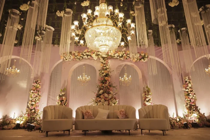 Pastel floral stage decor with chandeliers