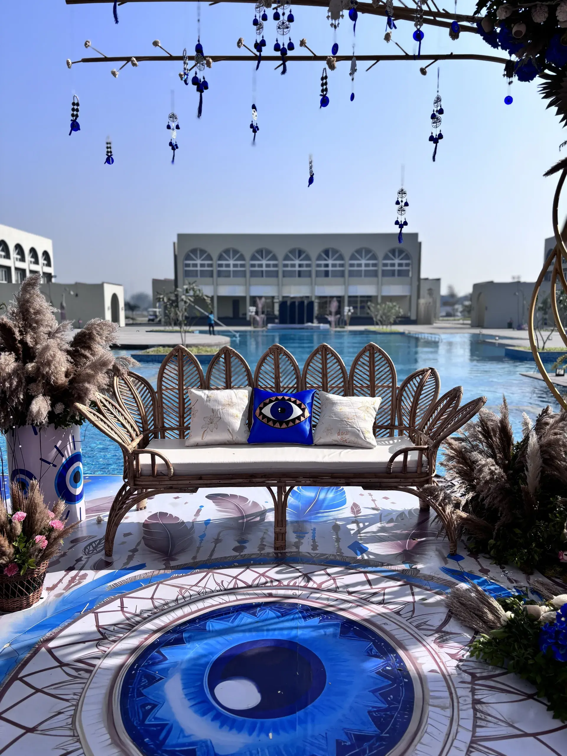 Poolside wedding decor with evil-eye styling