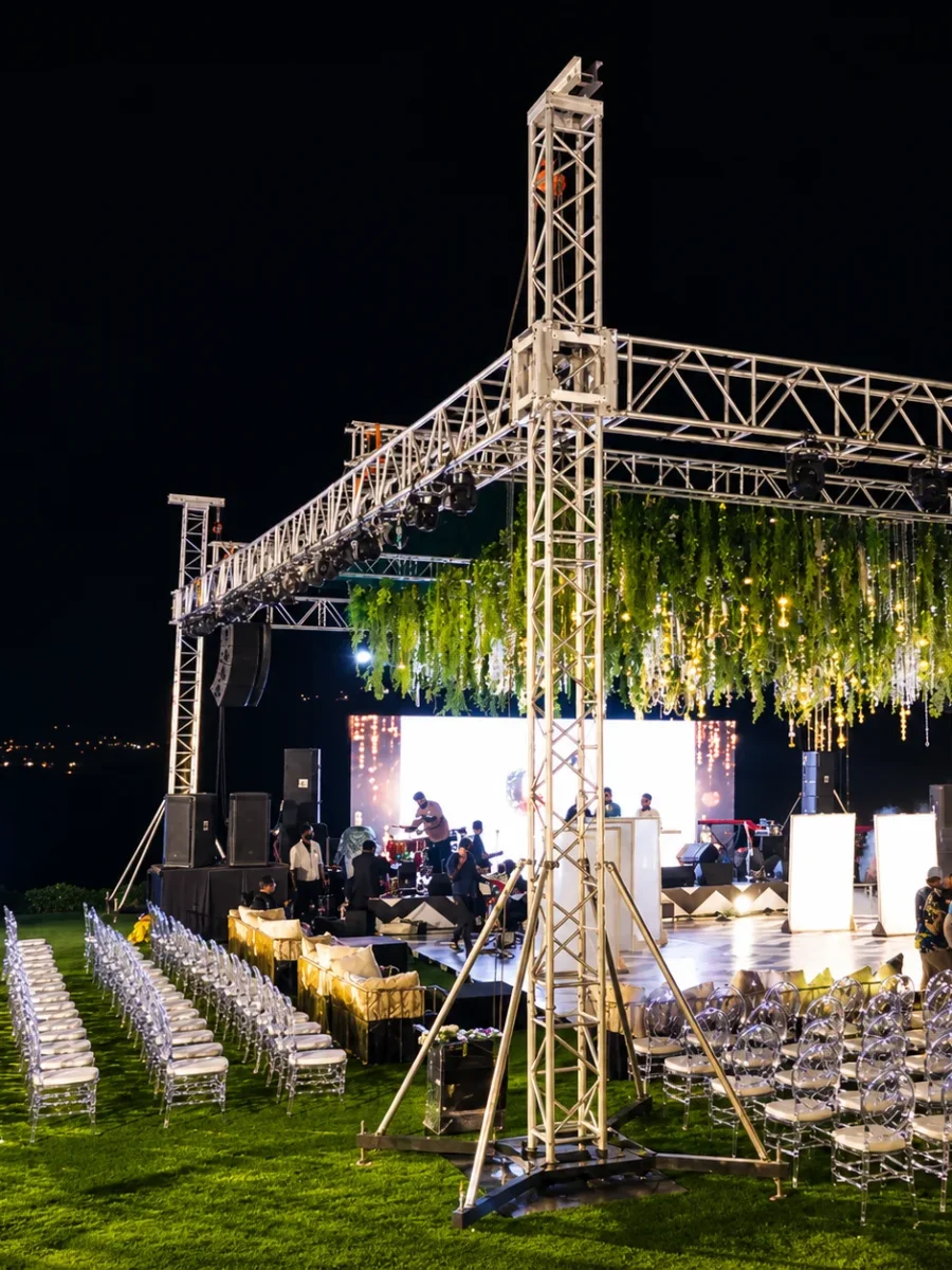 Evening social event with a lit stage and seating